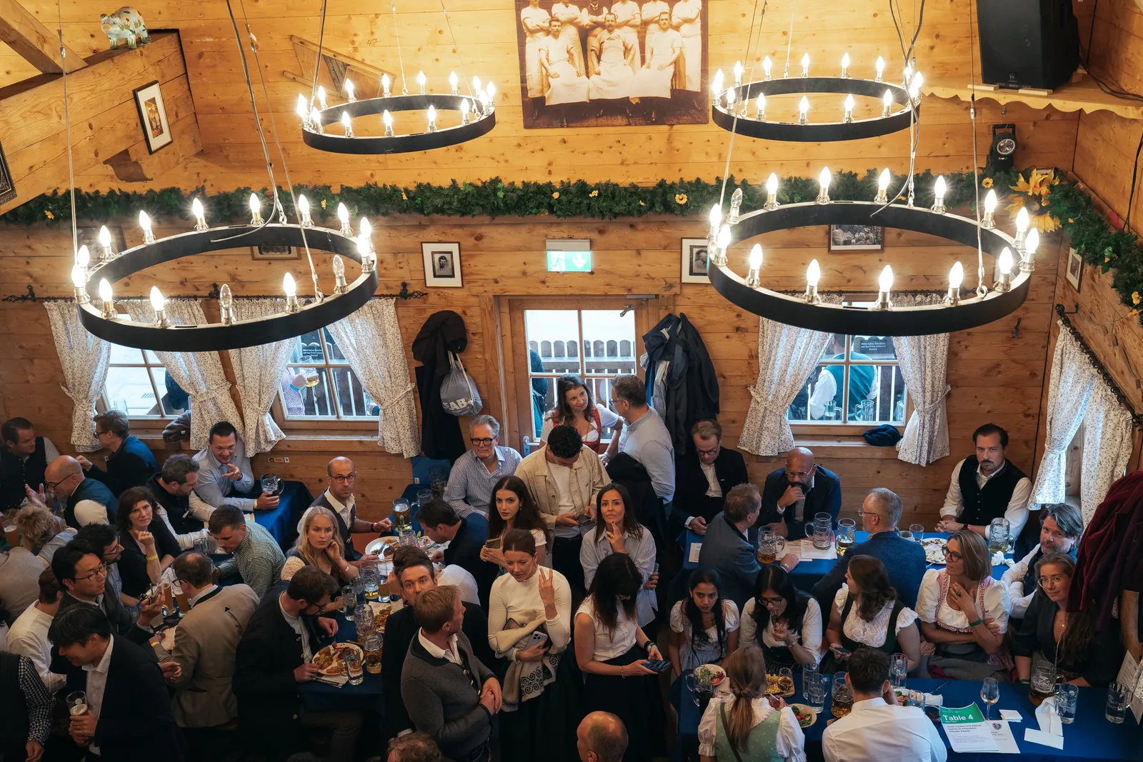 Guests gathered beneath the chandeliers in the Oktoberfest tent at Tech for Climate 2026
